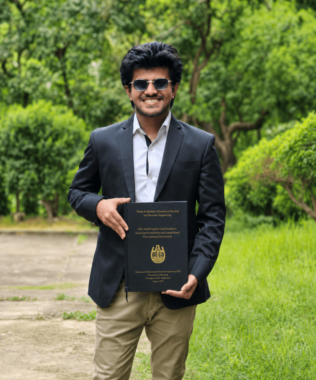 Tanvir Hossain Ovi holding his bound BSc thesis